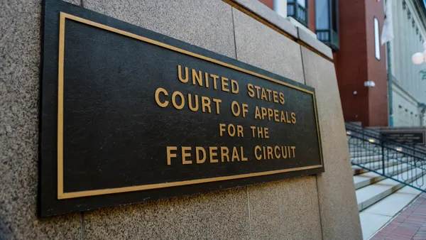 A sign on the outside of the U.S. Court of Appeals for the District of Columbia Circuit with stairs in the background.