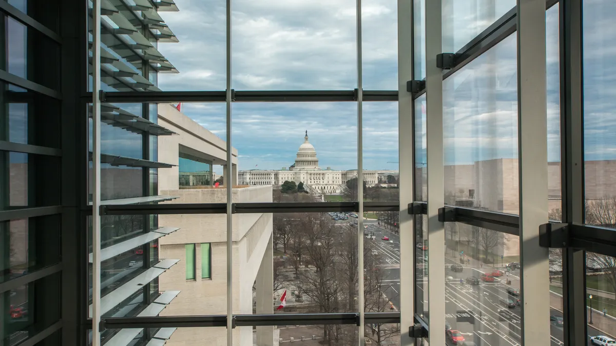 A bird's eye view of the West Facade of the U.S. Capitol Building and Pennsylvania Avenue in Washington, D.C., as seen from a window in a downtown office building.