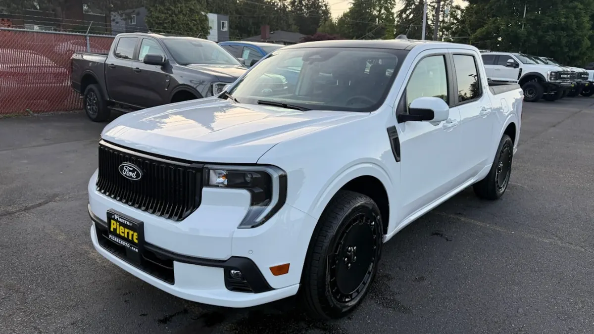 A white Ford Maverick Lobo pickup parked outside the Pierre Ford dealership in Seattle, Washington.