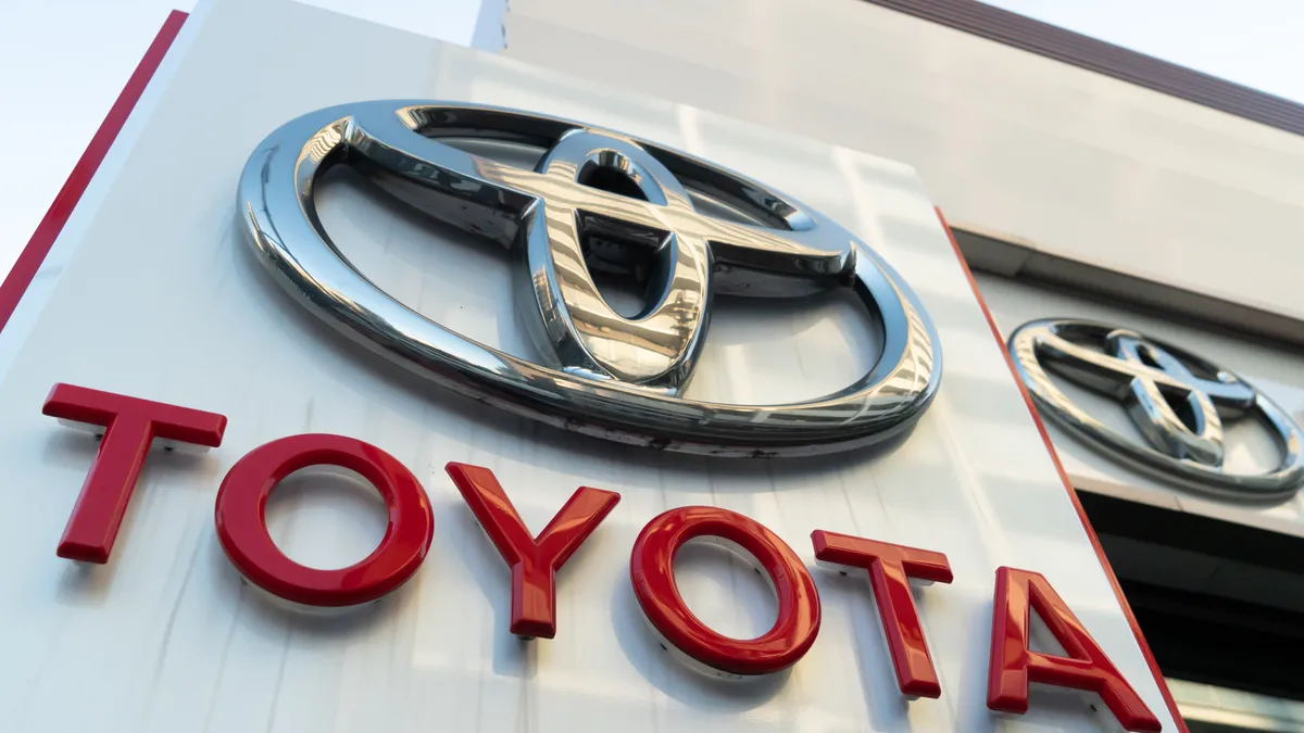 The Toyota logo is displayed outside a Toyota Motor Corp. dealership.