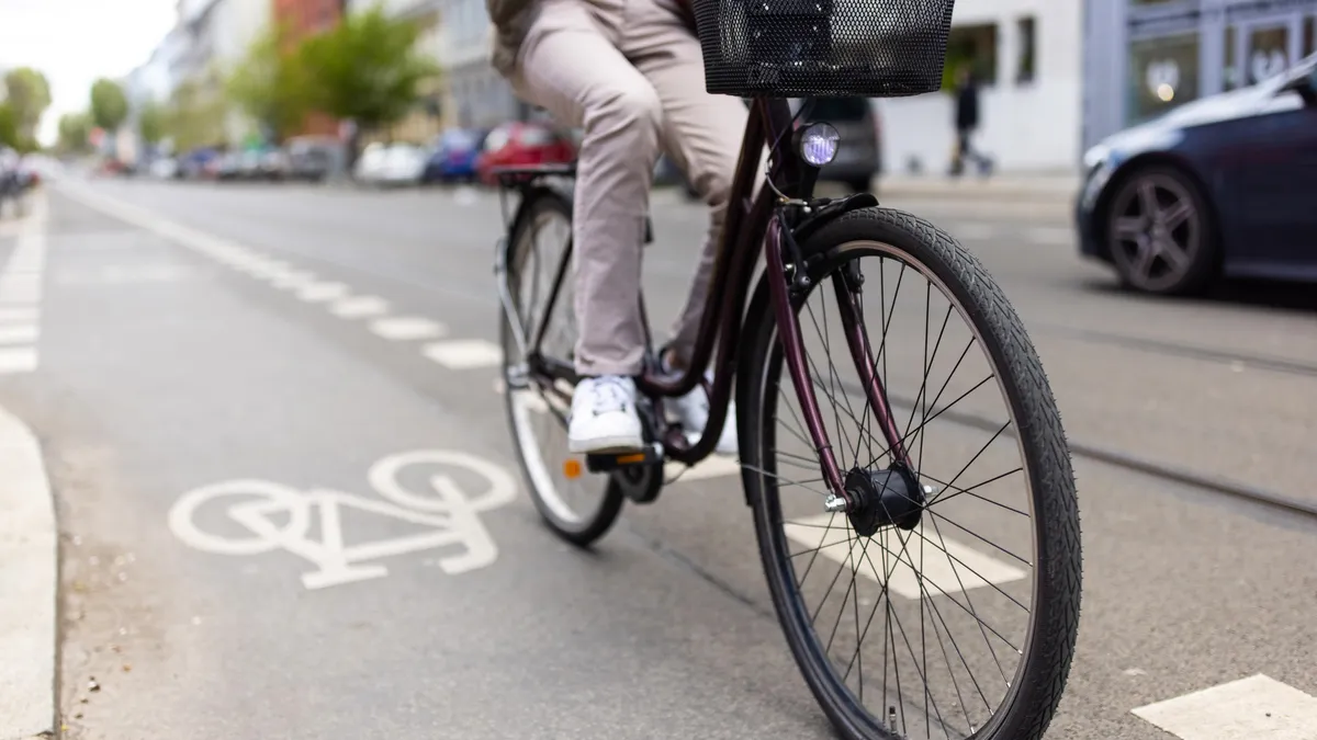 A man riding a bike in a dedicated bike lane.