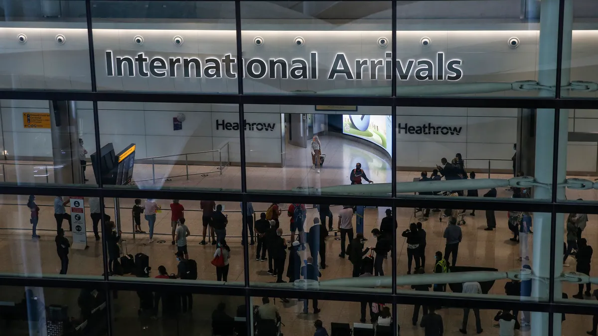 Travelers arrive at London's Heathrow Airport.