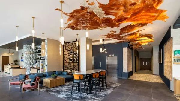 The lobby features bourbon-colored ceiling art.