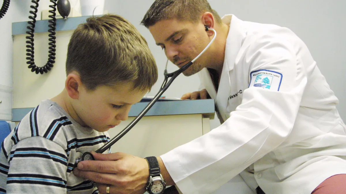 Doctor checks child's chest with stethoscope