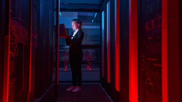 Female IT engineer working in server room