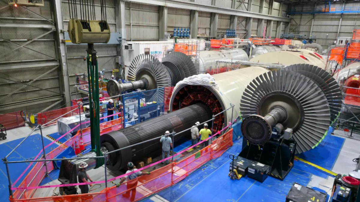 Crews reinstall a 183-ton turbine rotor at the Palisades power plant.