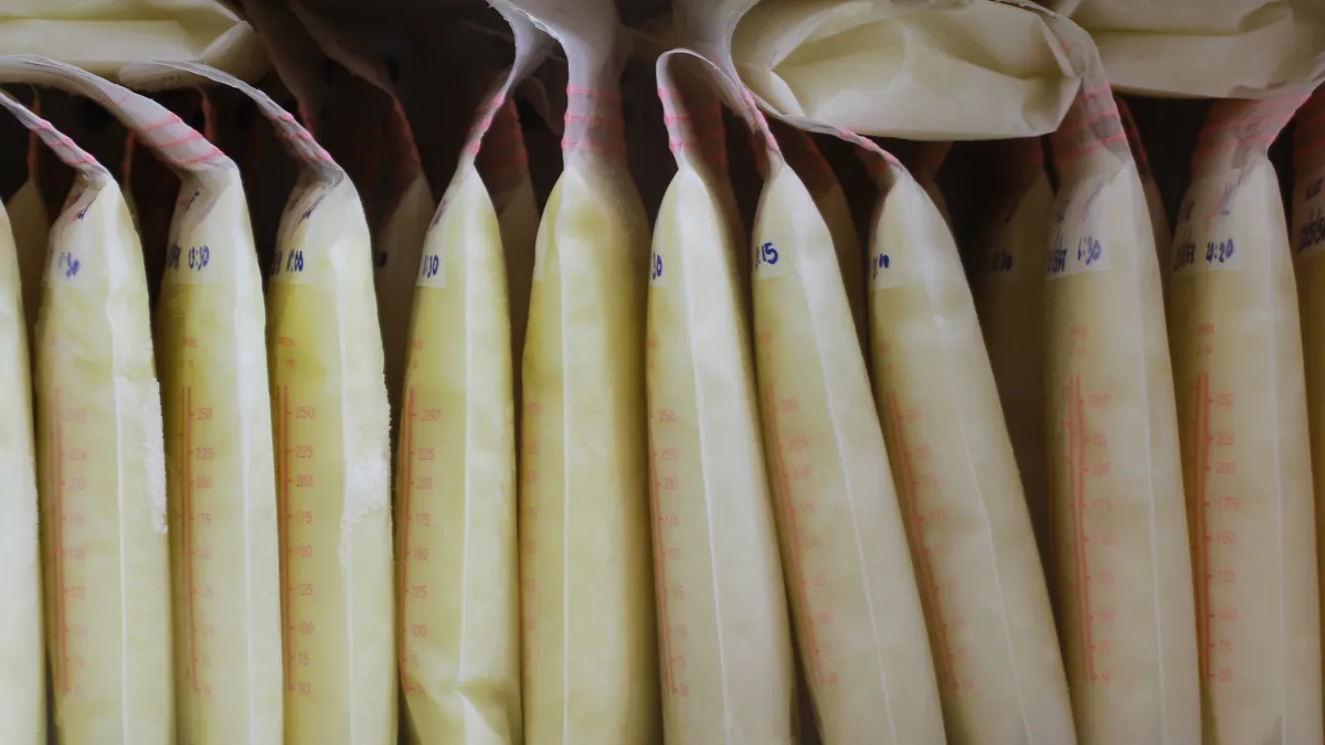 Bags of breast milk are nestled in a refrigerator