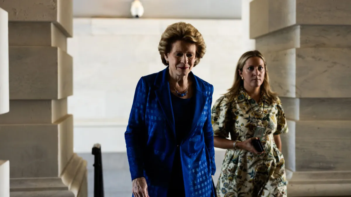 U.S. Sen. Debbie Stabenow is seen walking alongside a woman