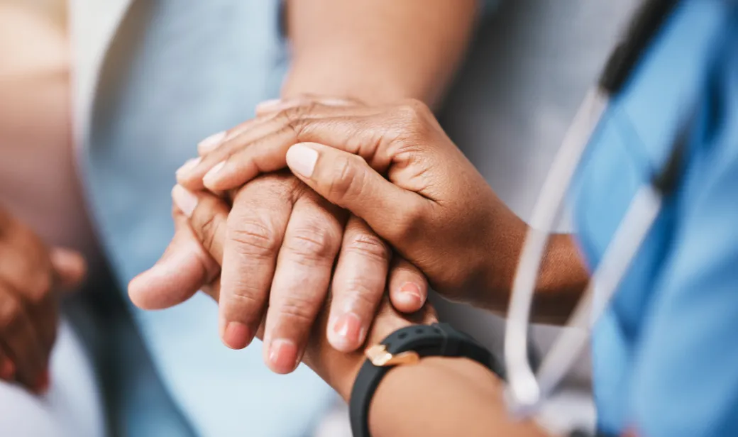 Nurse holding hands of patient