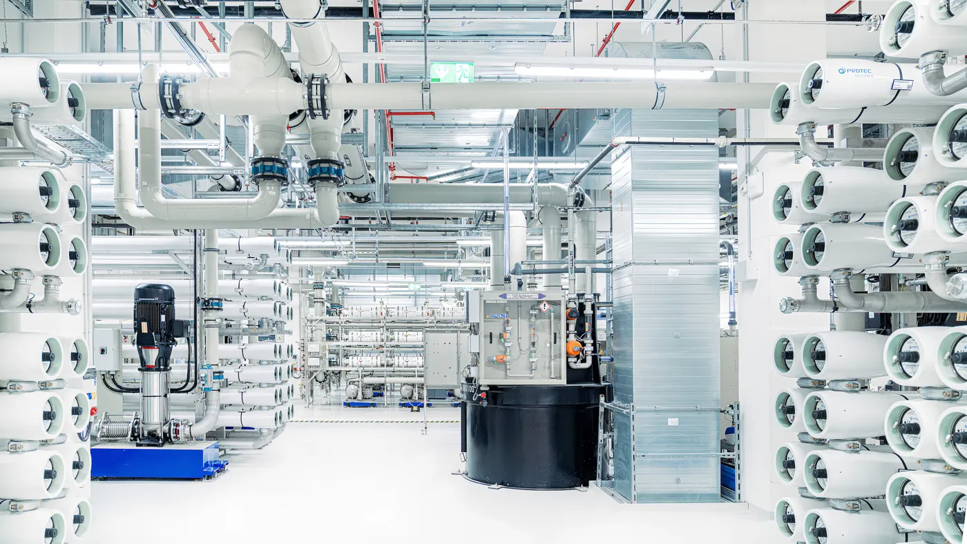 A white room full of pipes and water purification equipment