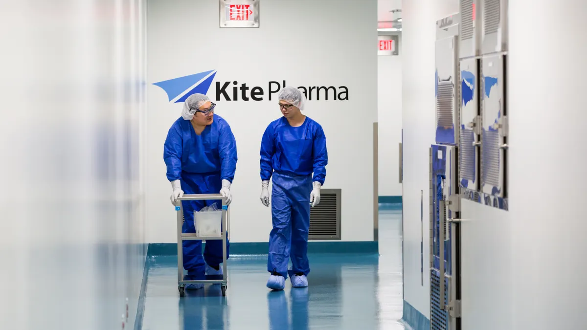 Two employees walk down a hallway in Gilead's Kite cell therapy unit.