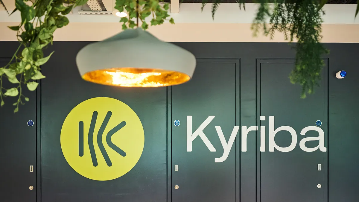 Kyriba's yellow logo appears to be painted on doors painted green.