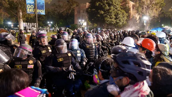 A group of police officers enter the protest encampment on UCLA's campus.