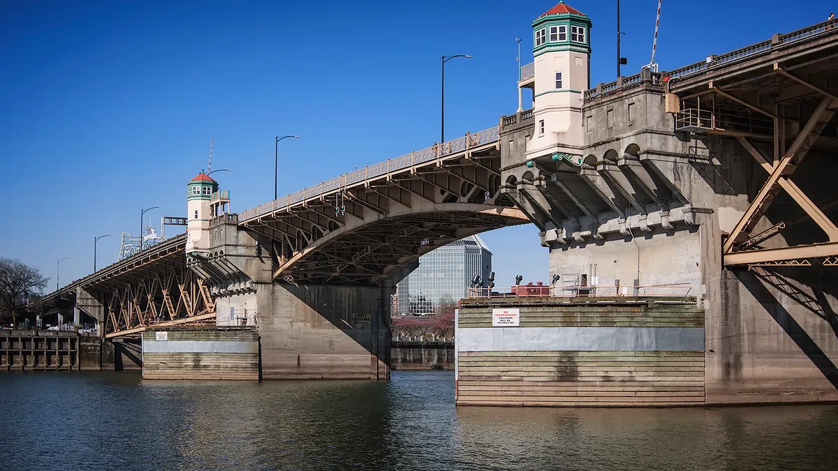 A shot of the Burnside Bridge in Portland, Oregon, over water on a sunny day.