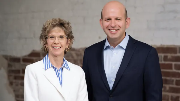 A portrait of ArcBest CEO Judy McReynolds and President Seth Runser side by side.