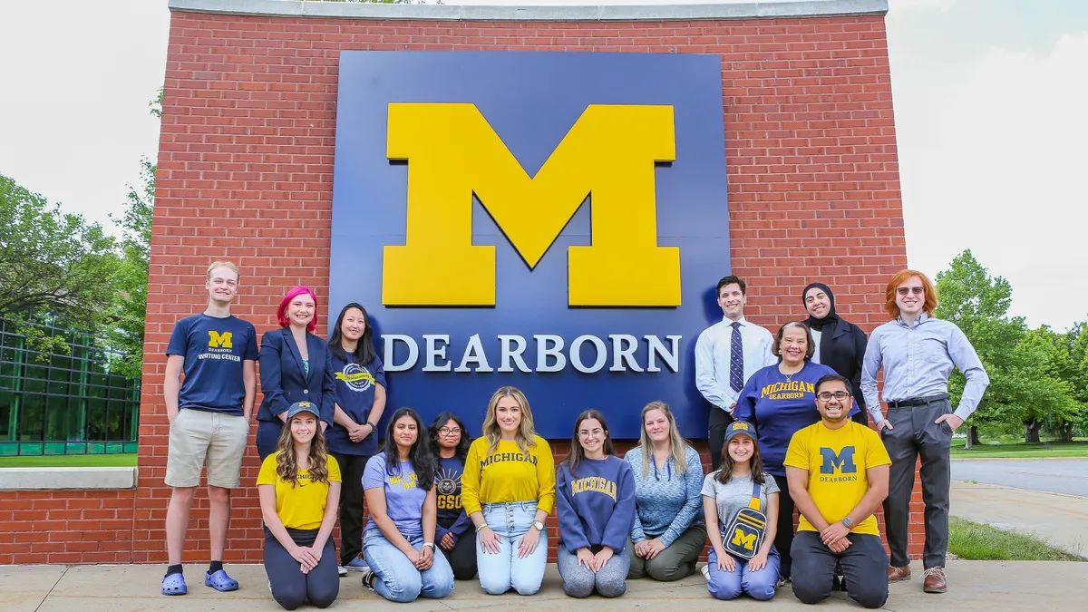 University of Michigan-Dearborn students in front of the university sign