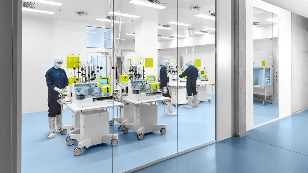 Workers in cell therapy lab