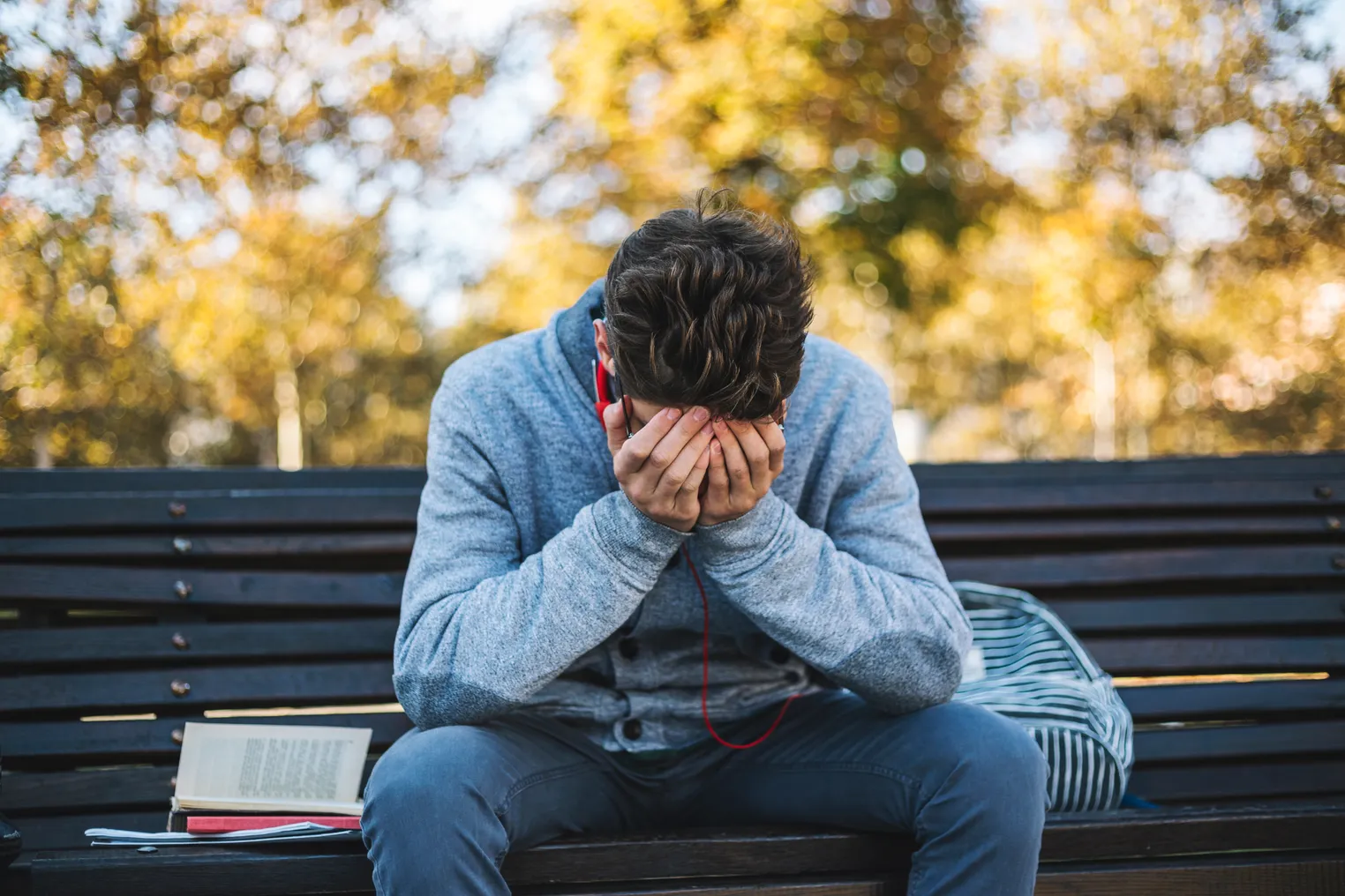 A student sits in a hallway.