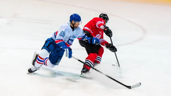 Ice hockey player playing ice hockey in ice hockey stadium.