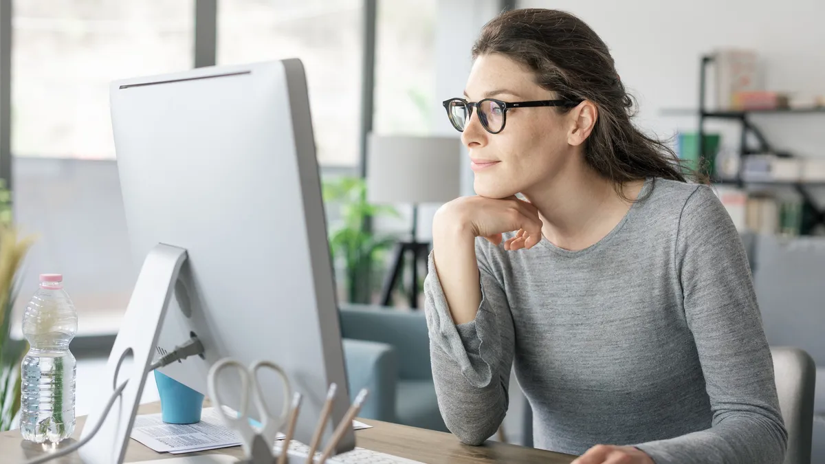 A female attorney working at her computer at home