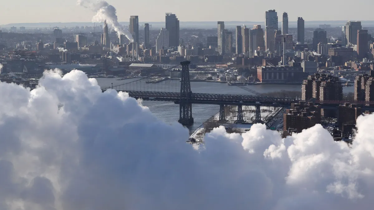 The Brooklyn Bridge seen as steam rises from the Con Edison power plant