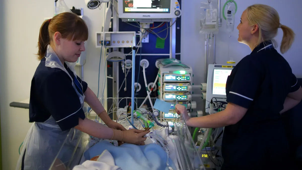 Nurses care for a newborn baby in the Neonatal Intensive Care Unit at Birmingham Women's Hospital