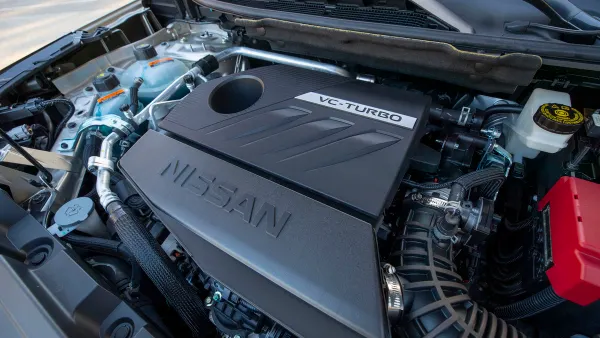 The engine bay of a 2023 Nissan Rogue showing the 3-cylinder turbo-charged engine.