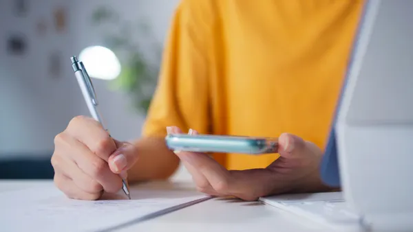a close up of a worker doing AI training using a phone