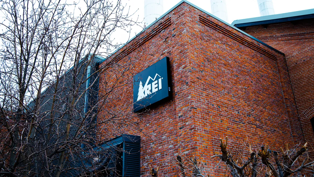 A red brick building with an REI sign on it.