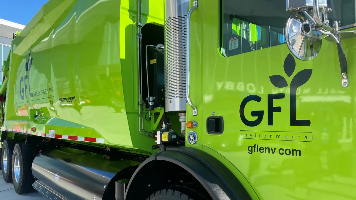 The exterior of a garbage truck with the GFL Environmental logo