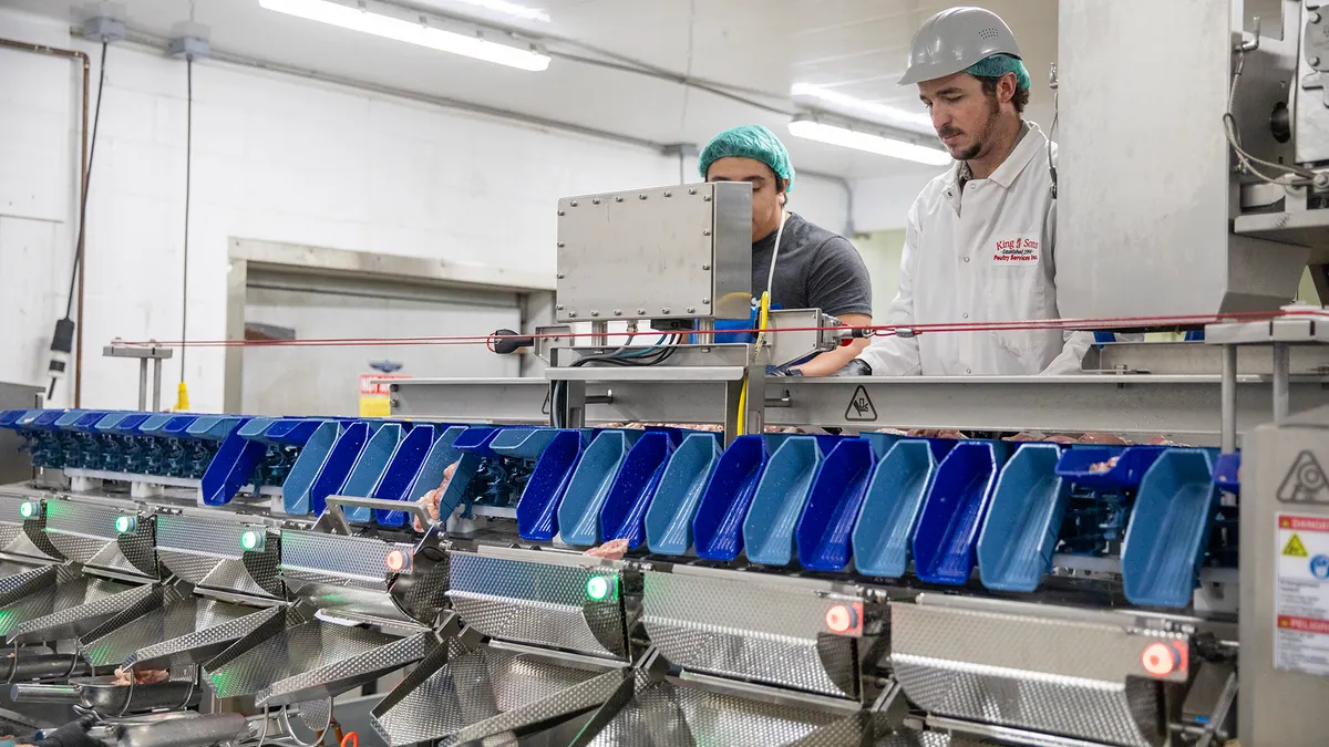 2 workers in King’s Poultry Farm's processing plant