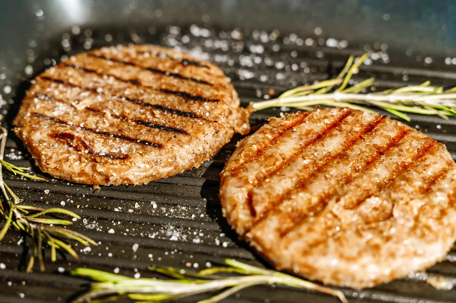 Veggie cutlet is grilled for veg burger. Vegetarian products from plant-based meat concept, beyond kitchen background. High quality photo