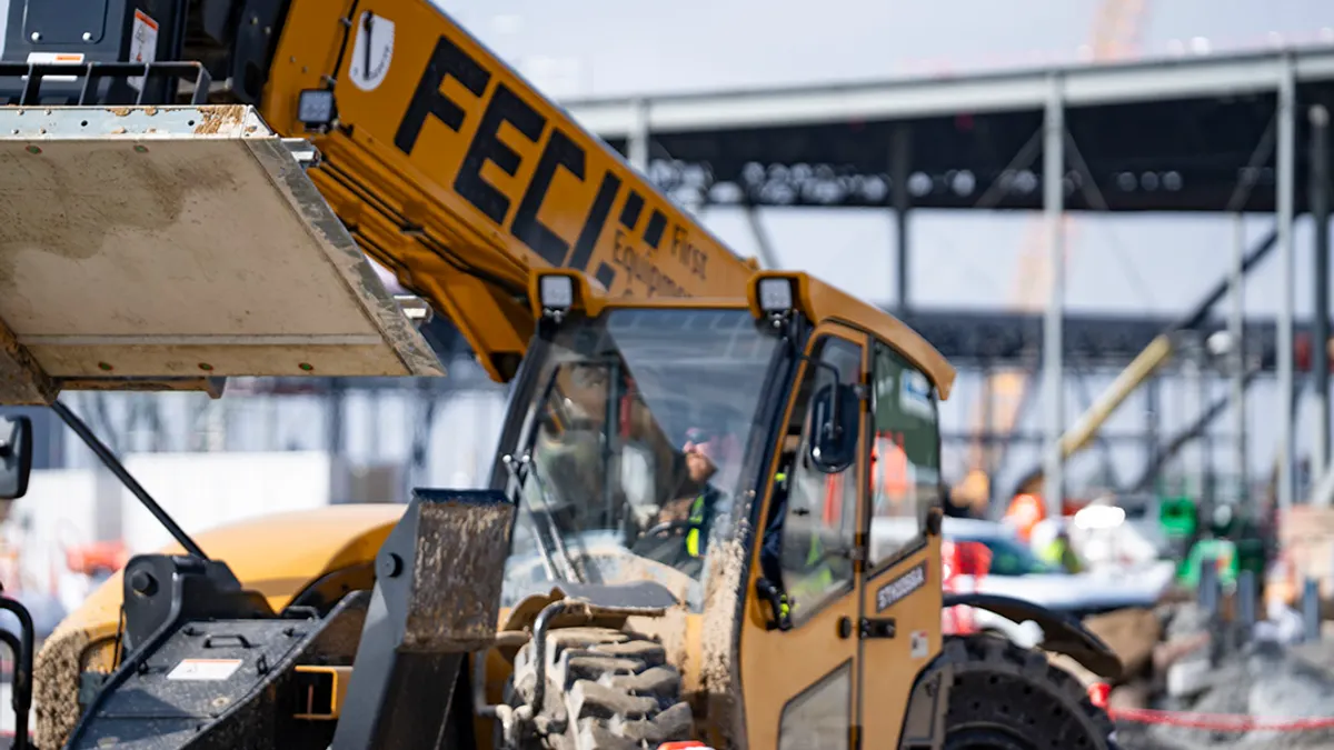 A photo of a piece of heavy machinery in the complete foreground with some writing emblazoned along it.