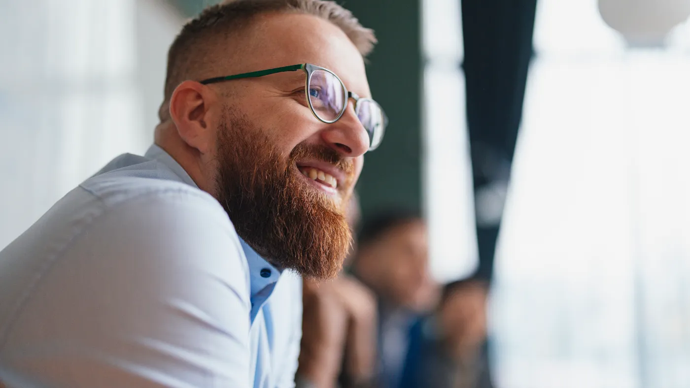 An employee smiles during a presentation.