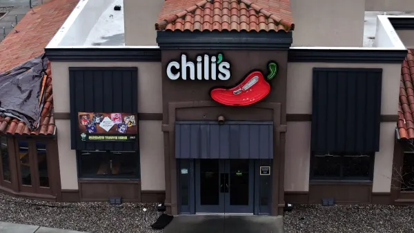 An aerial view of a building with white "Chili'"s sign alongside a red pepper.