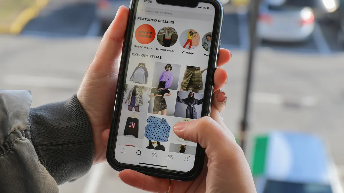 A phone user browses Depop's mobile app.