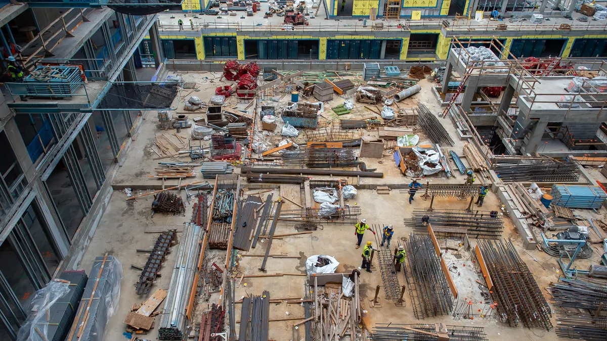 An aerial view of a construction jobsite with several piles of materials.