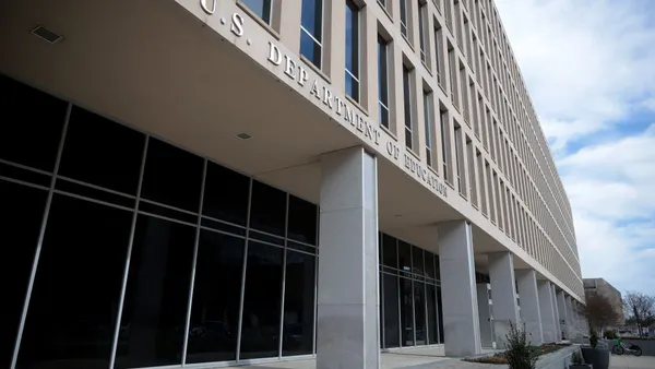 The camera shows the exterior of an off-white stone building with the working "U.S. Department of Education" on the side of the building
