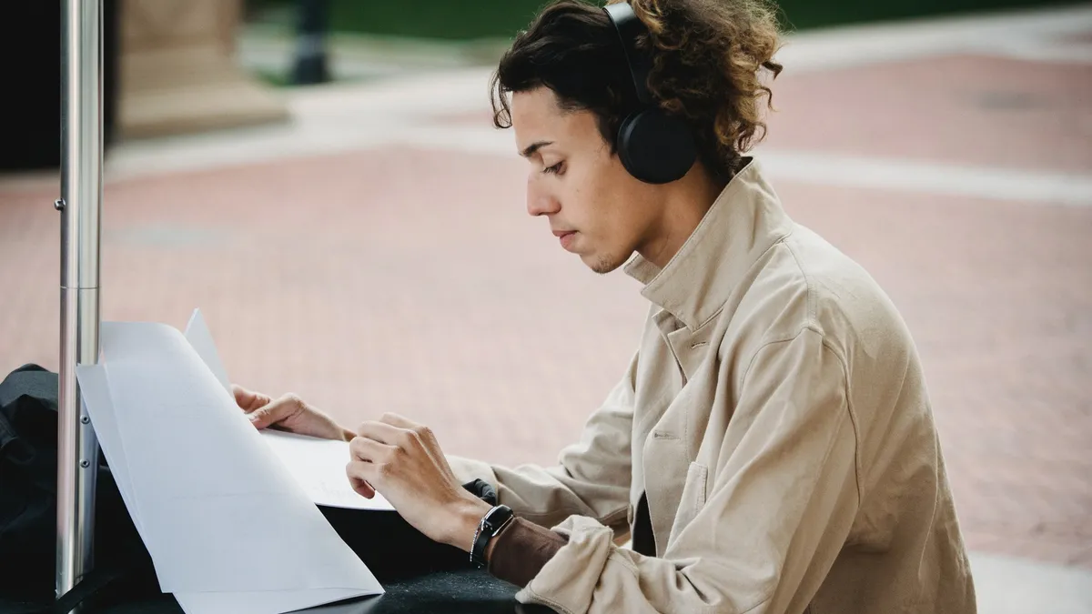 college student studies outside on campus