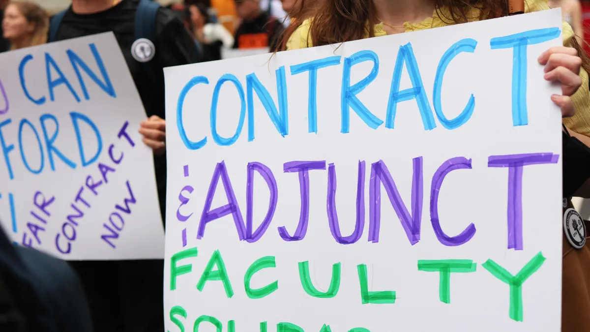 Signs call for contract and adjunct faculty solidarity.