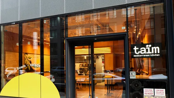 An exterior photo of a Taim restaurant.