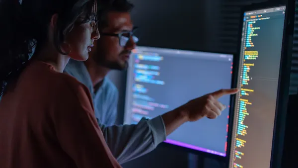 Computer, Female programmer and male training for coding, cyber security or software on computer. Female IT specialist, male coder or talking to connect internet, information update and cloud computing . coding development concept.