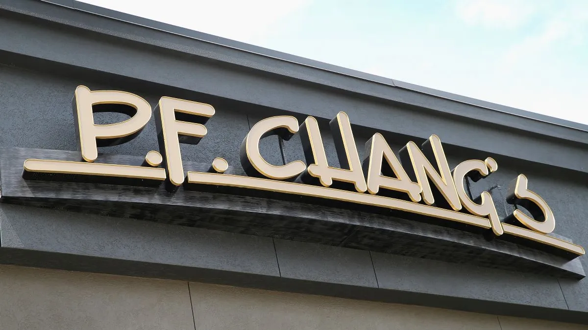 A zoomed in image of a building with gold signage. The sign says "P.F. Chang's."