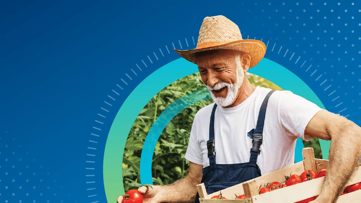 Farmer carrying box of tomatoes