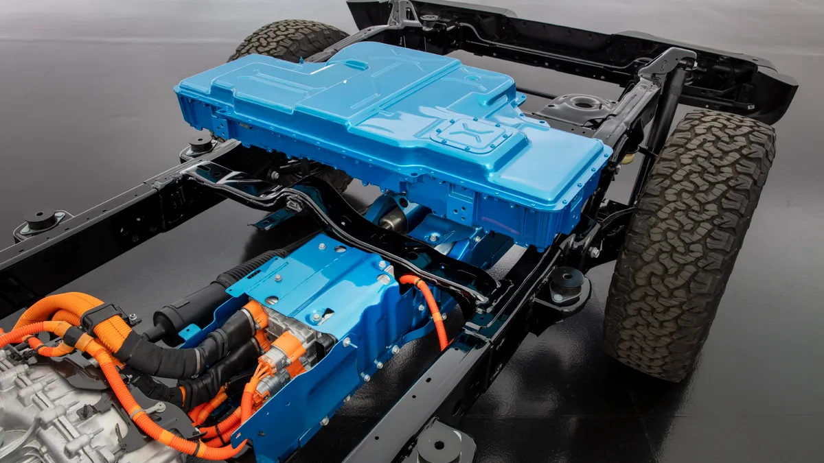 The chassis of the 2021 Jeep Wrangler 4xe showing the blue protective housing for the battery pack.