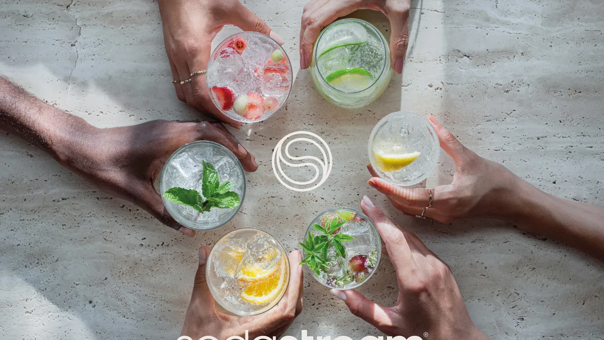 Five people hold glasses of SodaStream sparkling water