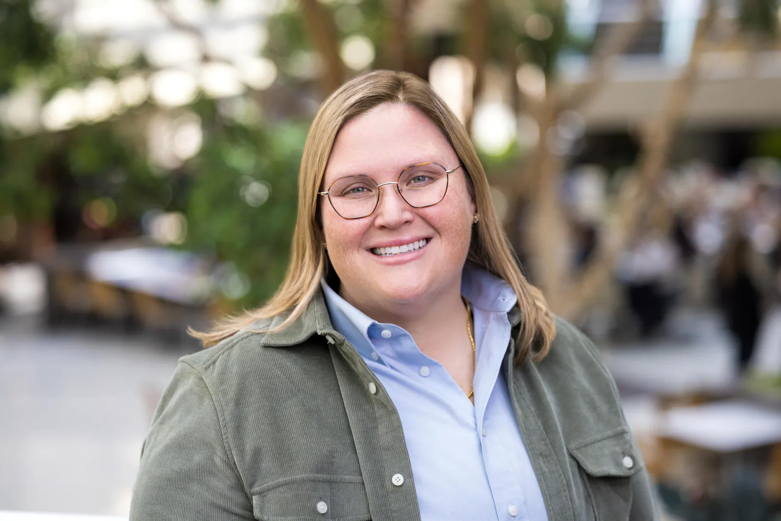 Albertsons executive Liz Roche stand outside wearing a green corduroy jacket and blue button up
