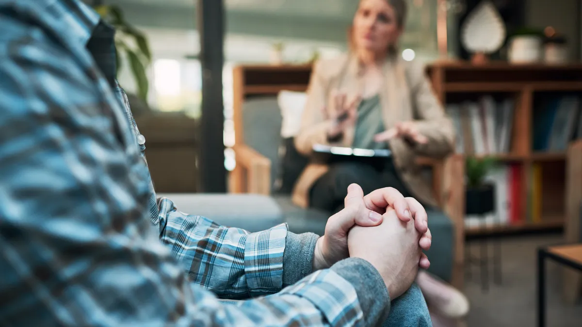 Cropped shot of a man having a therapeutic session with a psychologist.