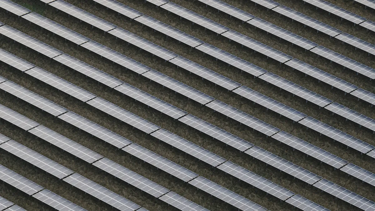 Rows of solar panels are seen from the air.