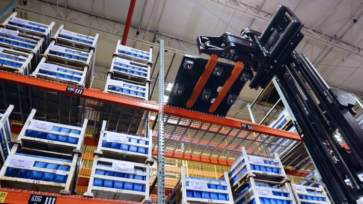 A Toyota forklift lifting a pallet in a warehouse.